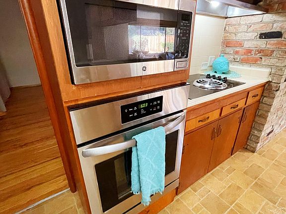 Kitchen with new microwave, stove, and cooktop