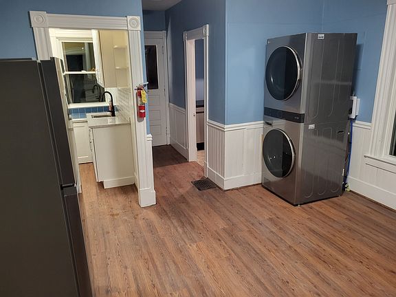 Kitchen view toward pantry, side entrance with entrance to half bath