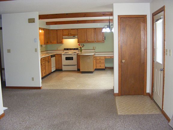 The living room flows into the kitchen area. Everything is