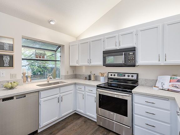Updated kitchen featuring stainless steel appliances and quartz countertops.