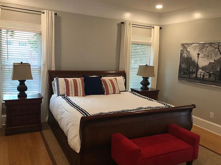 Master Bedroom - King Sleigh Bed, Nightstands, Cedar lined Dresser, Sitting Area, Exterior door to private balcony