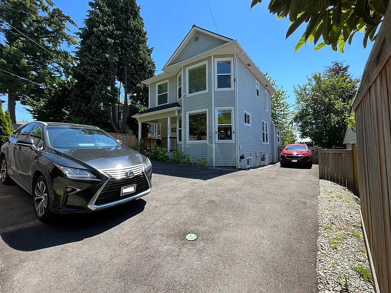 Thoughtful paved, off-street parking can easily accommodate four vehicles in your secured, fenced property