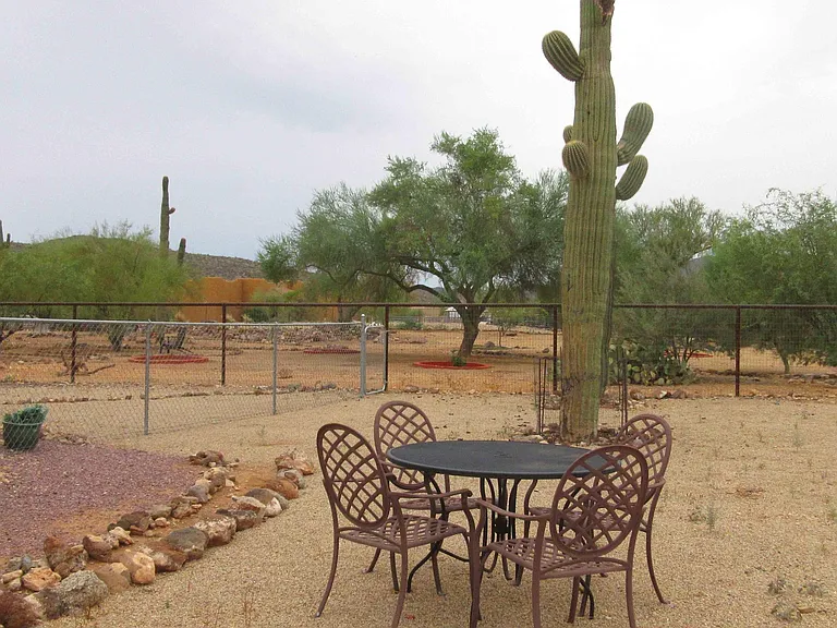 Fully Fenced Back Yard with Iron Table & Chairs
