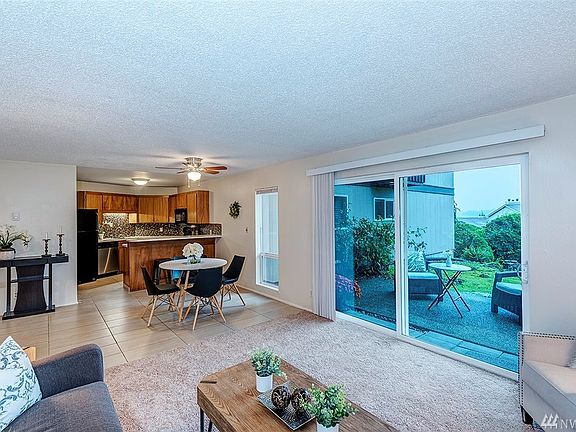 Alternate View Of The Living Room Shows The Updated Kitchen And Dining Area.