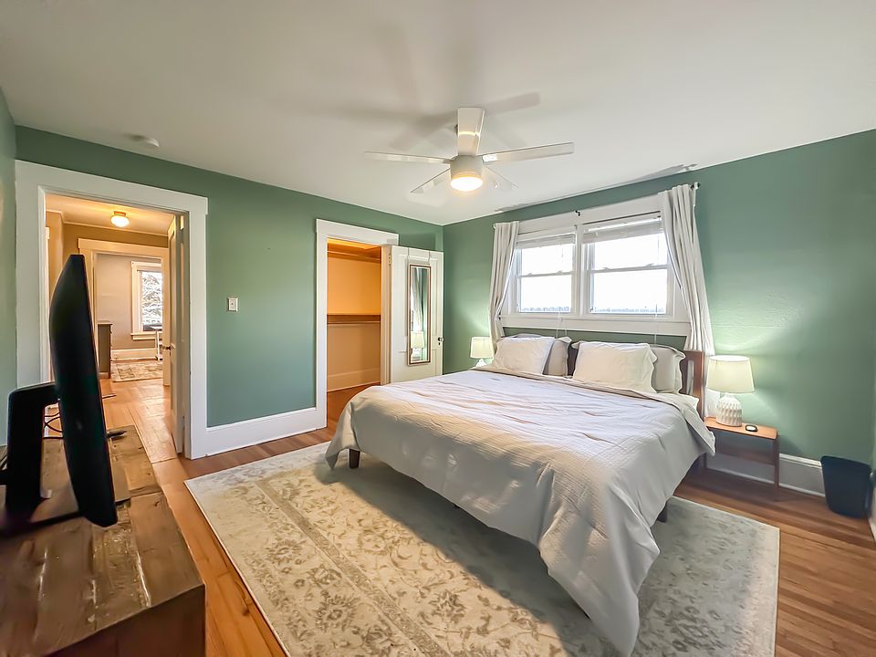 Master bedroom with king sized bed, walk-in closet