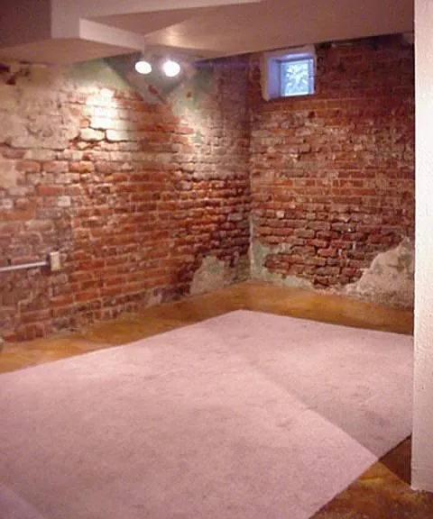 Stairs landing basement from across the room bedroom