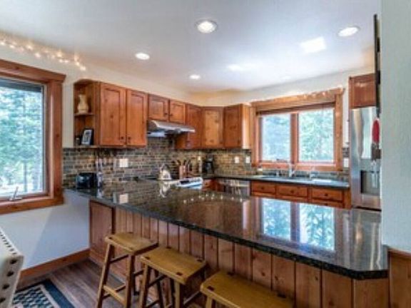 Kitchen area with seating at large peninsula