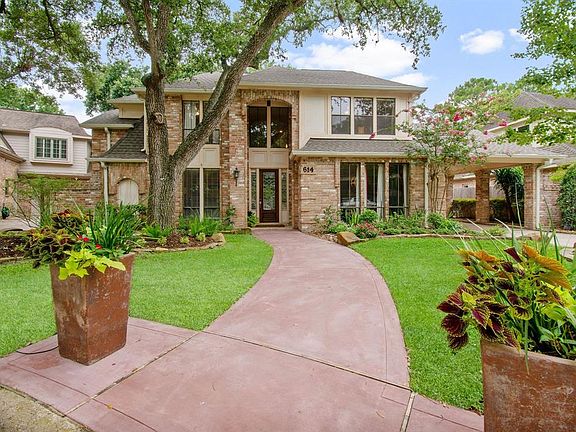 Beautiful landscaped yard with mature trees makes this home's curb appeal inviting and stately!