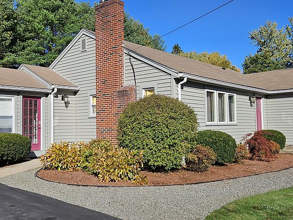 The entries to the house are framed with flowering bushes that take turns blooming throughout the growing season.