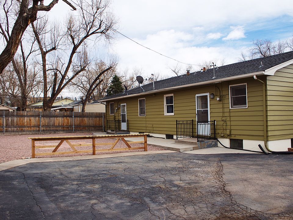Back of 4plex showing doors leading to downstairs unit