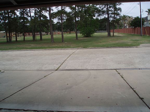 view of playground from 3 car garage