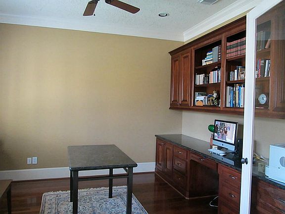 Study with hardwood floors and built-ins and granite tops.