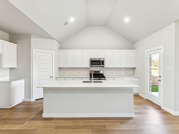 Kitchen in the Wimbledon home plan by Trophy Signature Homes - REPRESENTATIVE PHOTO