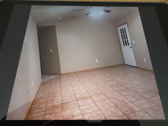 Living room with front door to upper right in photo.