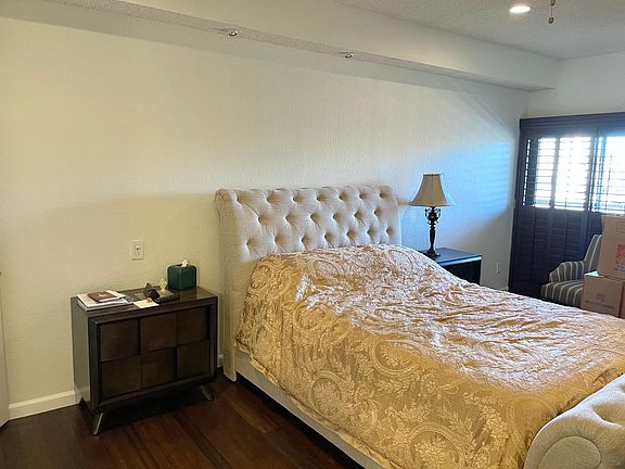 main bedroom with sliding french doors to balcony