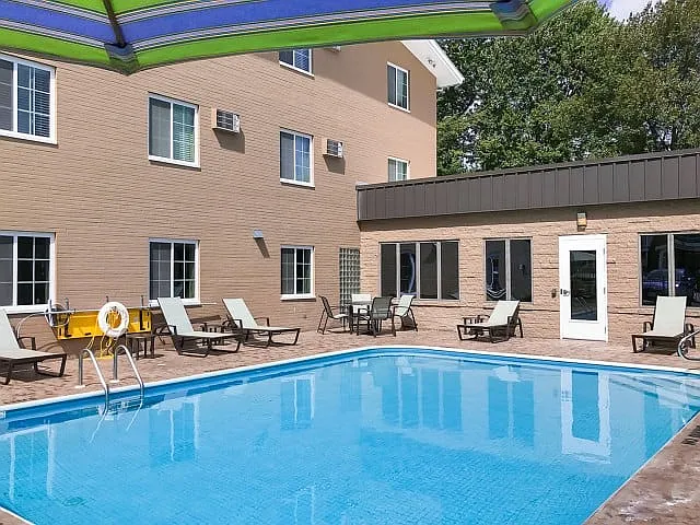 Relax and unwind by the pool at University Oaks Apartments in Kent, OH. - University Oaks