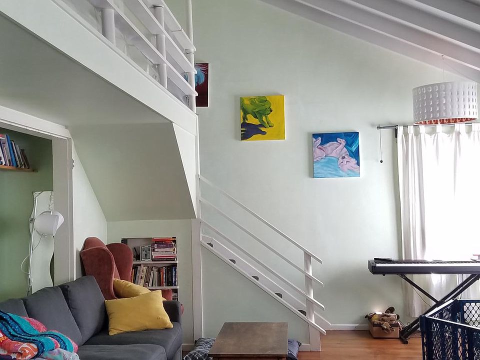 living room including balcony and stairs