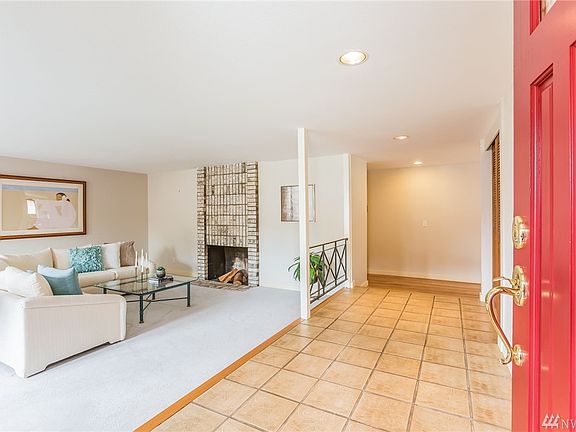 Enter on to decorative tile flooring next to your bright, welcoming living room.