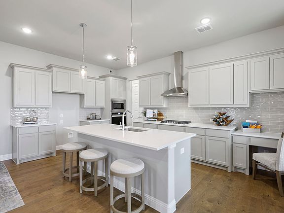 Kitchen in the Shiraz home plan by Trophy Signature Homes - REPRESENTATIVE PHOTO