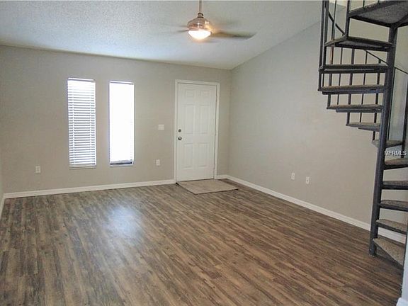 Entry at Living room with spiral staircase to Loft with closet