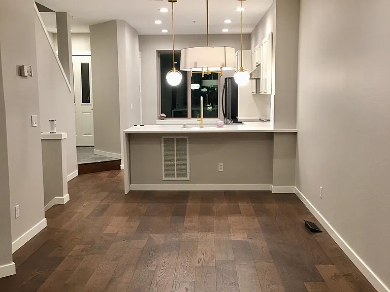 High quality engineered hardwood flooring throughout, except stairs. Fresh paint. Photo taken in the evening.