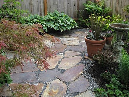 Small is beautiful in this slate patio in front of townhome.