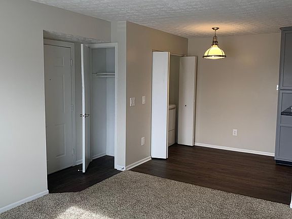 View of front door, coat closet, dining room from living room