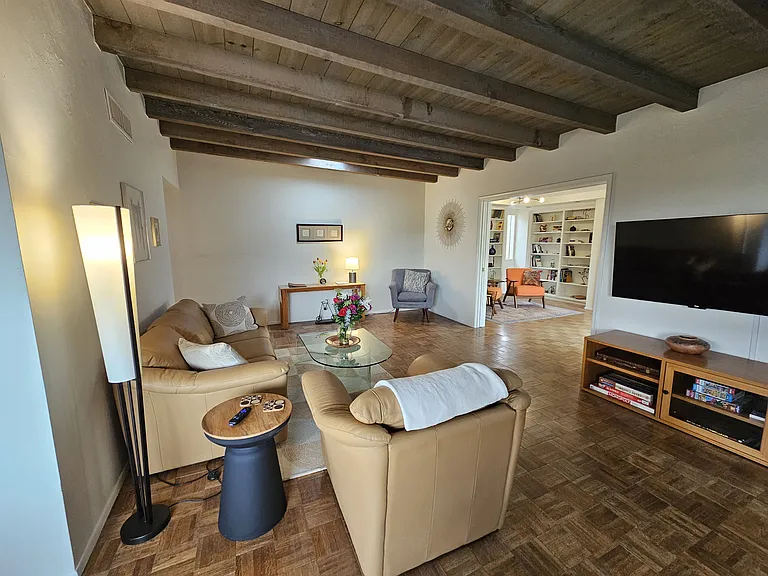 Pocket doors separate the living room from the office/study.