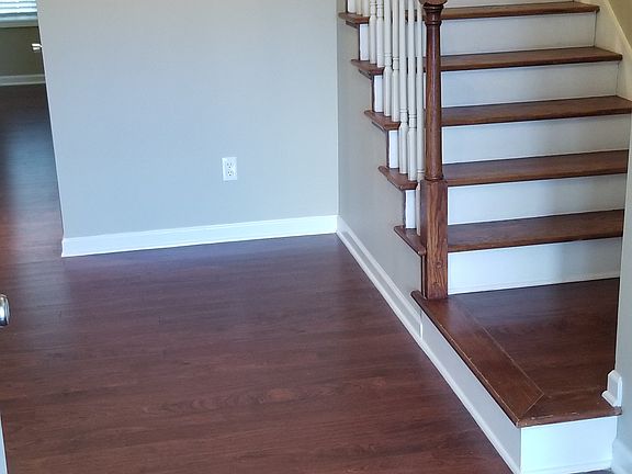 FRONT FOYER WITH COAT CLOSET AND STAIRCASE
