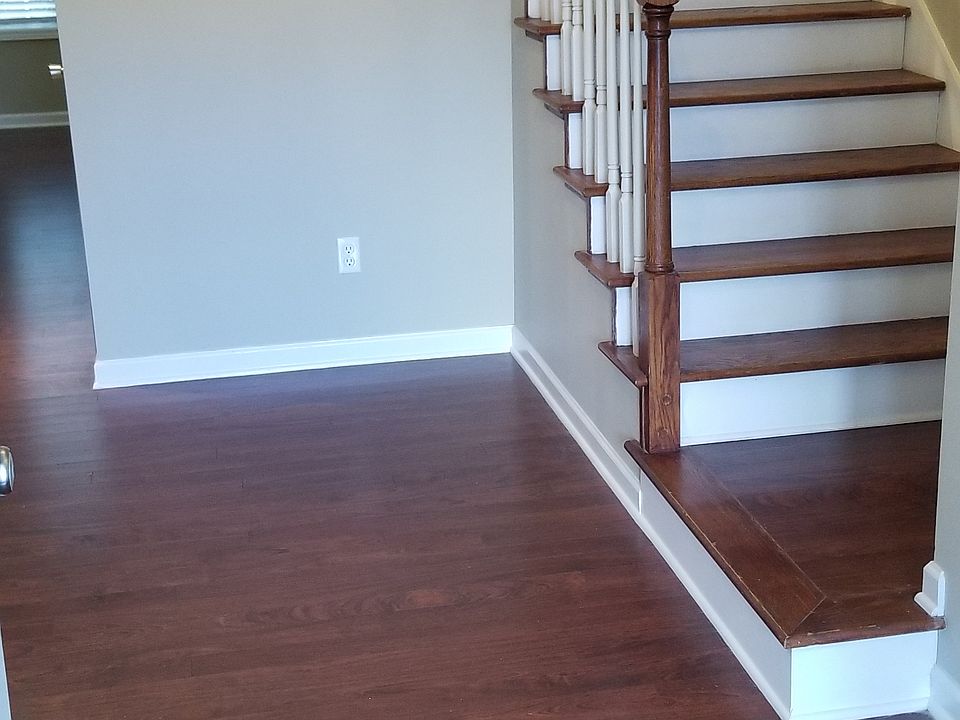 FRONT FOYER WITH COAT CLOSET AND STAIRCASE