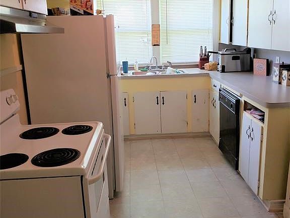 Kitchen area with electric range.