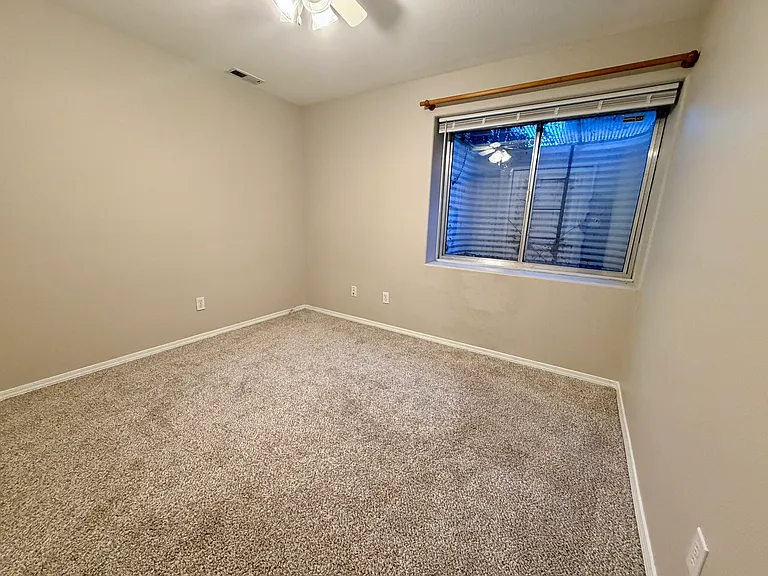 Additional view of the third bedroom highlighting the spacious layout, closet storage, and flexibility for use as a guest room, office, or personal retreat.