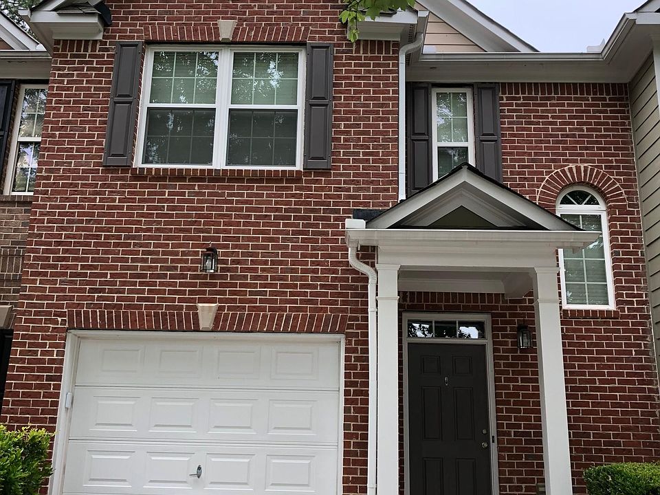 Brick townhome in Pinnacle Glen community. Lovely trees out front and shrubs maintained by association