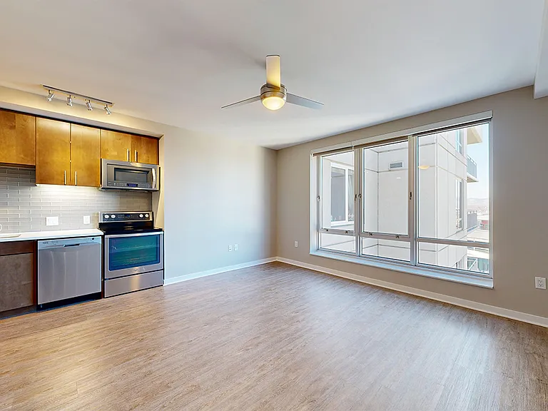 Apartment dining and living room with wood-style flooring.