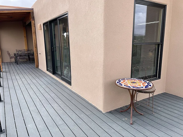 View towards the living room from the upper deck. Dining area near the kitchen on the far left