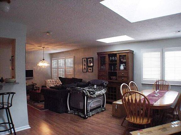 Wonderful living & dining room with skylite, custom Plantation Shutters !