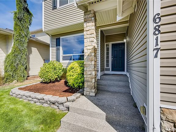 Lush curb appeal welcomes you to this turn-key two-story charmer with a covered front entrance. 