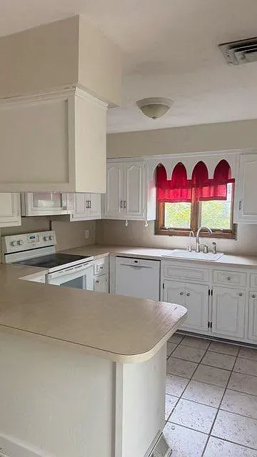 kitchen with white cabinets and large counter space - 21 Hamilton Ave