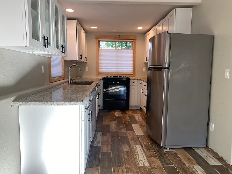 Kitchen has granite countertops, lots of cabinet space, dishwasher, gas stove and tile floors. All Windows are above ground for light and emergency exits.