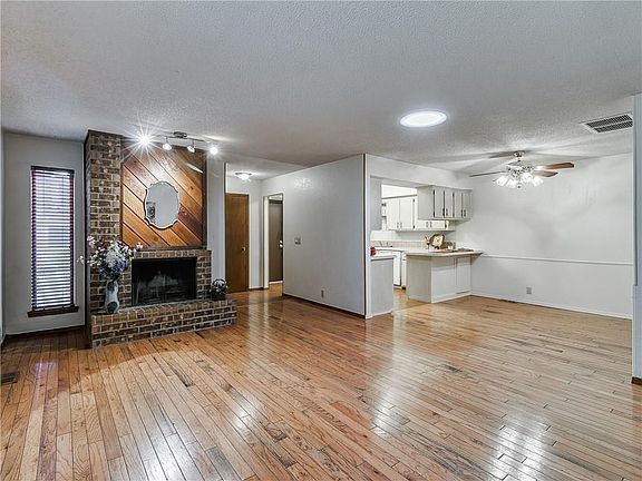 The real wood floors add a nice touch to this sweet lo-maintenance house.  The brick fireplace is a great focal piece and the solar tube offers a perfect amount of natural light.