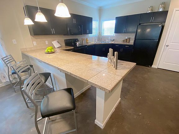 Spacious kitchens featuring a breakfast bar overlooking the living area.