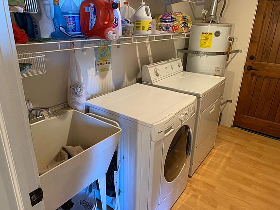 Laundry room with door to EXT
