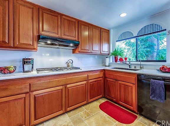 The backsplash is also quartz. The flooring is saw-cut travertine.
