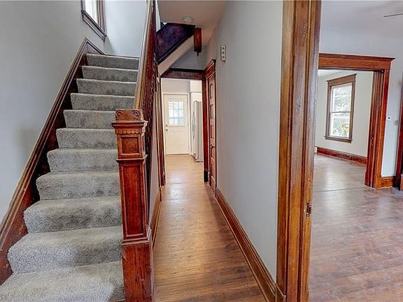 Entry way with view of kitchen, living room and dining room with pocket doors.