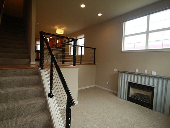 The sunken living room with fireplace is the perfect place to hang out with family and friends.