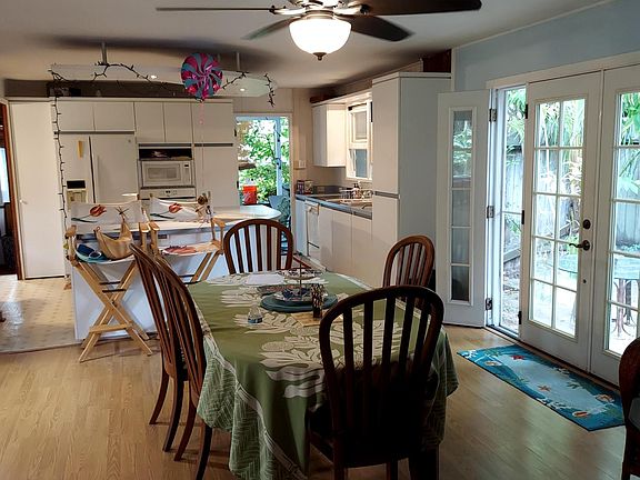 dining area adjoins kitchen and opens to living room. New fan above table.
