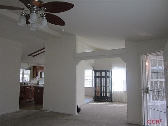 Large open living room. You can see to the kitchen and dining room.