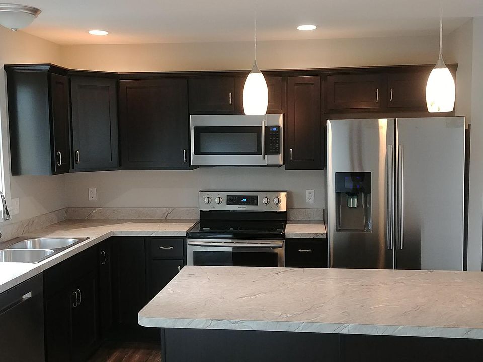 Kitchen featuring all new appliances cabinets and island wit