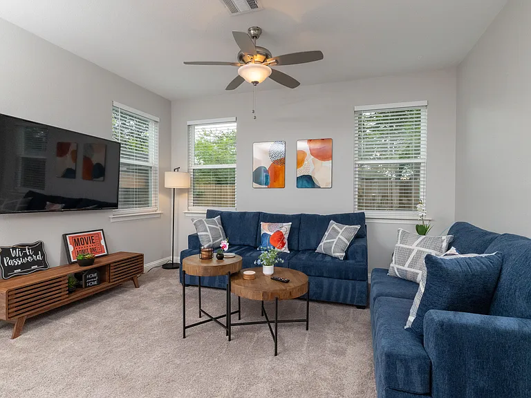Spacious open living room with two comfy couches and a large flat-screen TV_perfect for relaxing nights in or movie marathons.