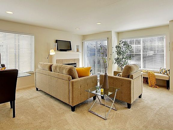 Alternate view of living room showing wall of windows and slider to deck.